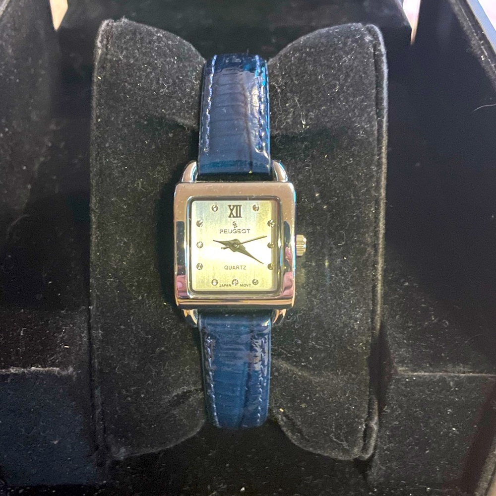 Peugeot ladies watch. Crystal face, polished stainless steel case, blue band